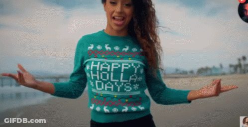 A Woman Wearing A Sweater That Says Happy Holly Days On It GIF
