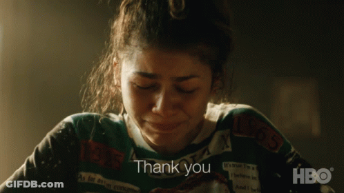 A Woman Wearing A Sweater That Says Thank You On It GIF
