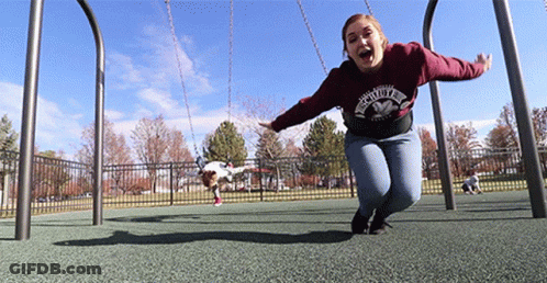 A Woman Wearing A Sweatshirt That Says ' Faith ' On It Is Swinging On A Swing Set GIF