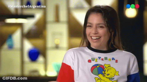 A Woman Wearing A T-Shirt That Says Masterchef Argentina Smiles GIF