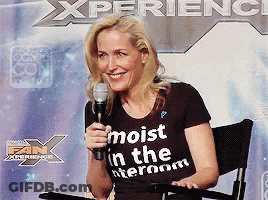 A Woman Wearing A T-Shirt That Says Moist In The Interroom GIF