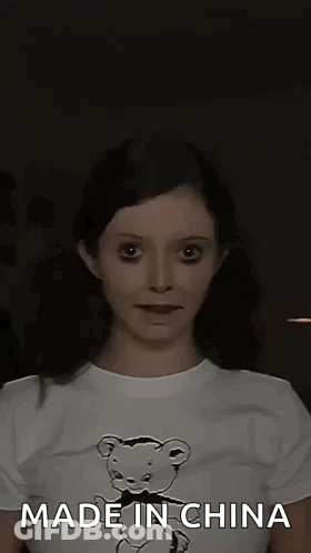 A Woman Wearing A T-Shirt With A Teddy Bear On It Is Making A Funny Face . GIF