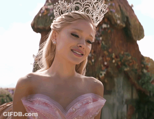 A Woman Wearing A Tiara And A Pink Dress GIF