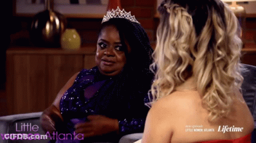 A Woman Wearing A Tiara Is Sitting Next To Another Woman With The Words Little Women Atlanta On The Bottom GIF