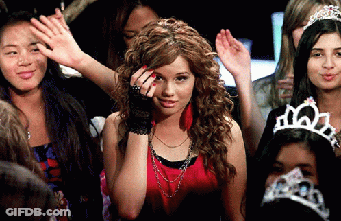 A Woman Wearing A Tiara Stands In A Crowd GIF