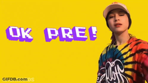 A Woman Wearing A Tie Dye Shirt And A Baseball Cap Says Ok Pre GIF