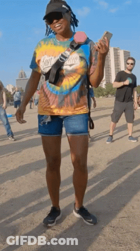 A Woman Wearing A Tie Dye Shirt With San Diego On It GIF