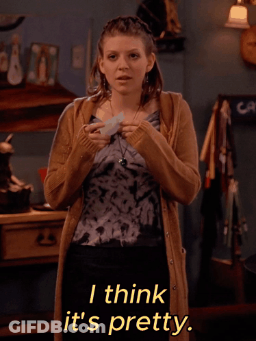 A Woman Wearing A Tie Dye Top And A Tan Cardigan Says I Think It 'S Pretty GIF