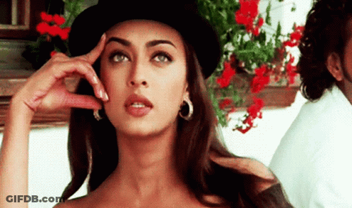 A Woman Wearing A Top Hat And Hoop Earrings Is Thinking GIF