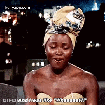 A Woman Wearing A Turban Is Sitting On A Couch And Talking . GIF