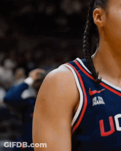 A Woman Wearing A Uc Jersey Stands On A Court GIF