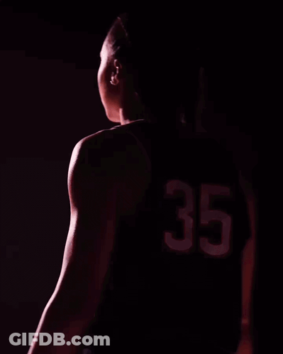 A Woman Wearing A Uconn Jersey With The Number 35 GIF