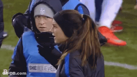 A Woman Wearing A Vest That Says She Believes On It GIF