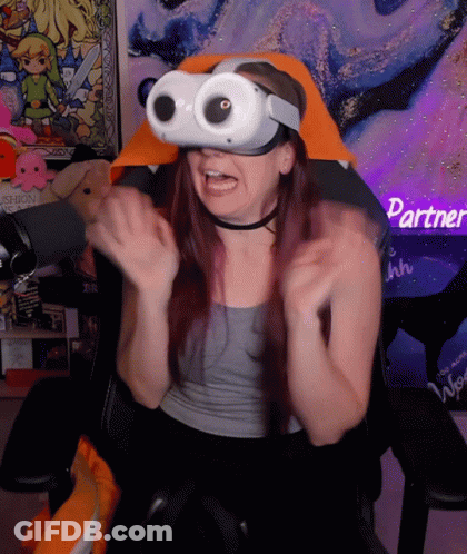 A Woman Wearing A Virtual Reality Headset Sitting In A Chair GIF
