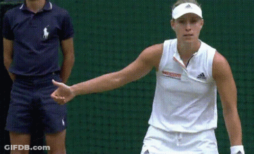 A Woman Wearing A White Adidas Shirt Stands In Front Of A Green Net GIF