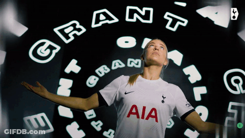 A Woman Wearing A White Aia Jersey Stands In Front Of A Circle Of Letters GIF