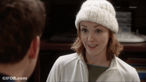 Woman In White Beanie And Jacket Smiling At Man GIF