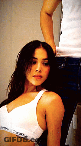A Woman Wearing A White Calvin Klein Bra GIF