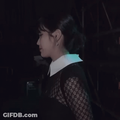 A Woman Wearing A White Collared Shirt Covering Her Mouth With Her Hands GIF