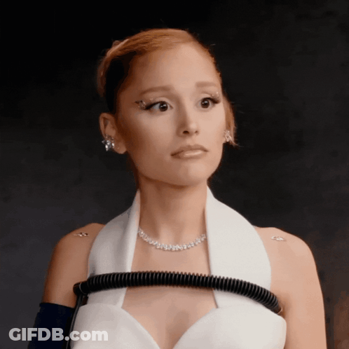 A Woman Wearing A White Dress And A Necklace With Rhinestones GIF