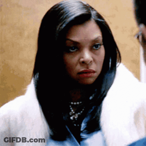 A Woman Wearing A White Fur Coat And A Blue Shirt Is Looking At A Man . GIF