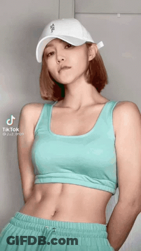 A Woman Wearing A White Hat And A Crop Top Has Tiktok Written On The Bottom GIF