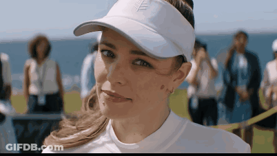 A Woman Wearing A White Hat With A Leaf On The Front GIF