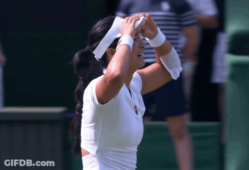A Woman Wearing A White Headband And White Wristbands Wipes Her Forehead GIF