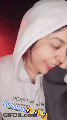 A Woman Wearing A White Hoodie That Says " Ha Ha Ha " On It GIF