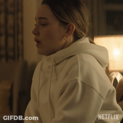A Woman Wearing A White Hoodie With The Word Netflix On The Bottom GIF