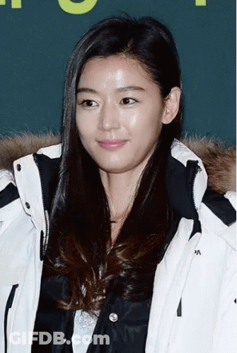 A Woman Wearing A White Jacket With The Letter A On The Collar GIF