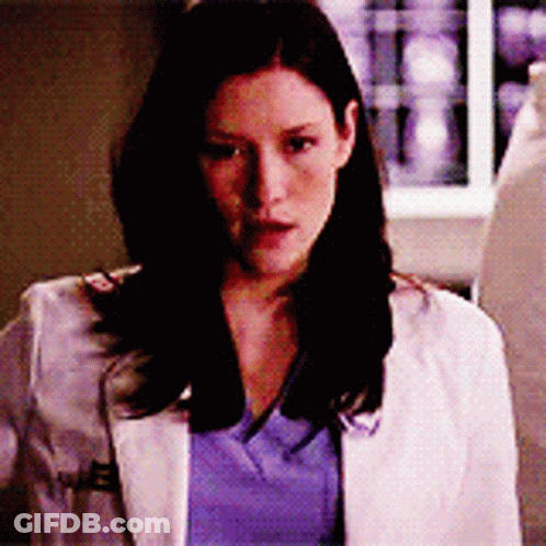 A Woman Wearing A White Lab Coat And A Blue Shirt GIF