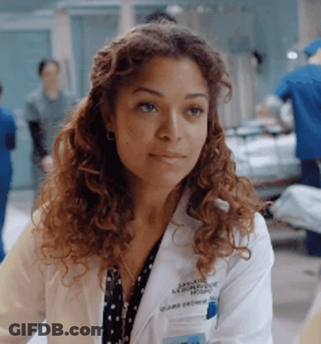 A Woman Wearing A White Lab Coat With The Name Claire Devore On It GIF