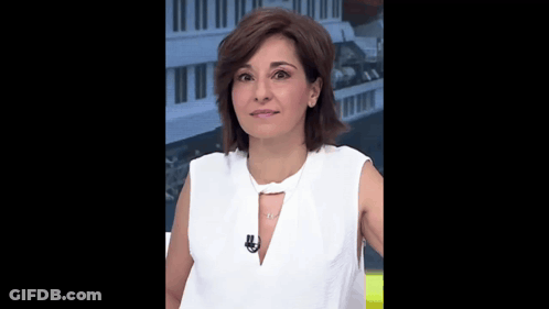 A Woman Wearing A White Shirt And A Necklace With A Microphone On Her Neck GIF