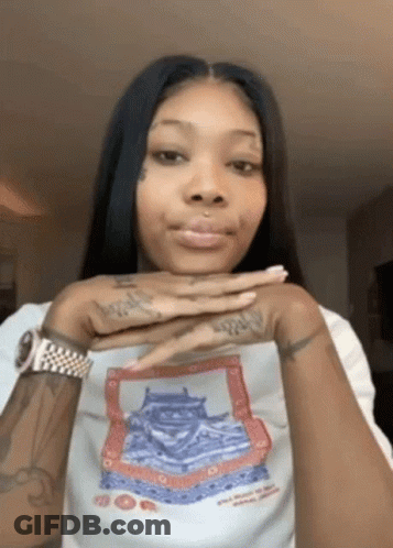 A Woman Wearing A White Shirt With A Picture Of A Castle On It . GIF
