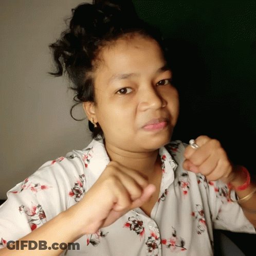 A Woman Wearing A White Shirt With Flowers On It GIF