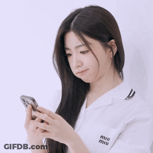 A Woman Wearing A White Shirt With Miu Written On The Pocket GIF