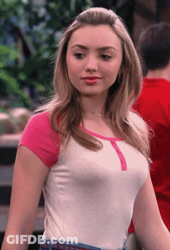 A Woman Wearing A White Shirt With Pink Sleeves And Jeans GIF