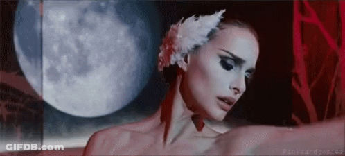 A Woman Wearing A White Swan Feather In Her Hair Is Dancing In Front Of A Full Moon . GIF