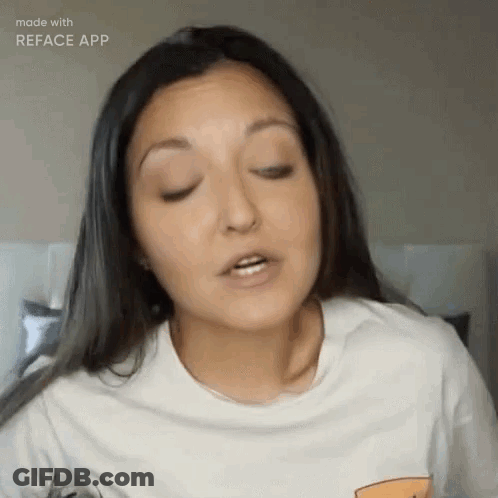 A Woman Wearing A White T-Shirt Is Making A Funny Face . GIF