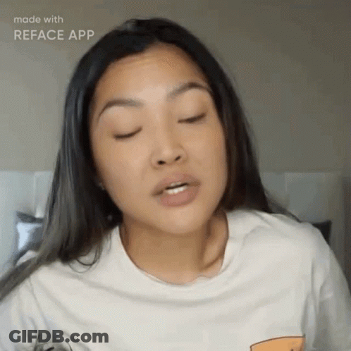 A Woman Wearing A White T-Shirt Is Making A Funny Face With Her Eyes Closed GIF