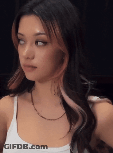 A Woman Wearing A White Tank Top And A Gold Chain GIF
