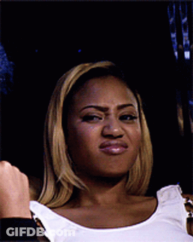 A Woman Wearing A White Tank Top Making A Funny Face GIF