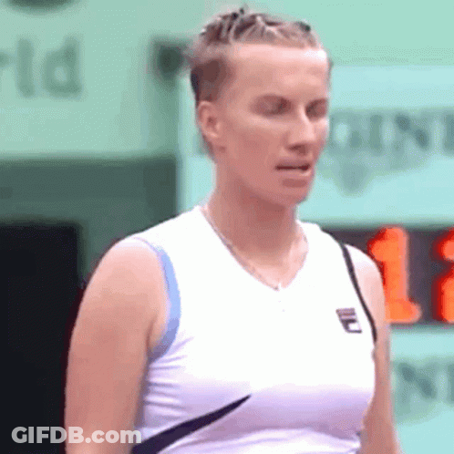 A Woman Wearing A White Tank Top With A Fila Logo On The Front GIF