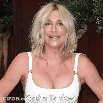 A Woman Wearing A White Tank Top With The Name Kesha Tanked On The Bottom GIF