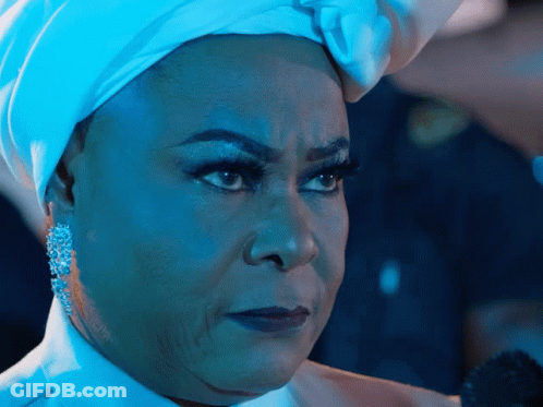 A Woman Wearing A White Turban And Earrings Looks Serious GIF