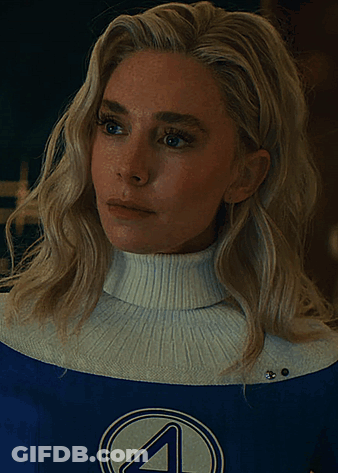 A Woman Wearing A White Turtleneck And A Blue Superhero Costume With The Letter 4 On It GIF