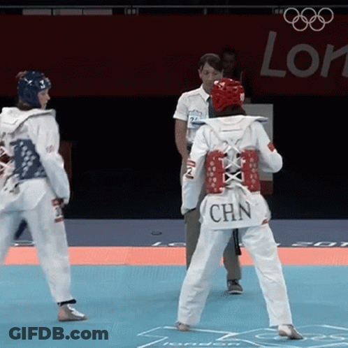 A Woman Wearing A White Uniform With Chn On The Back GIF