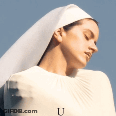 A Woman Wearing A White Veil Has The Letter U On Her Sleeve GIF