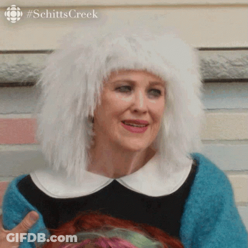 A Woman Wearing A White Wig And A Blue Sweater GIF